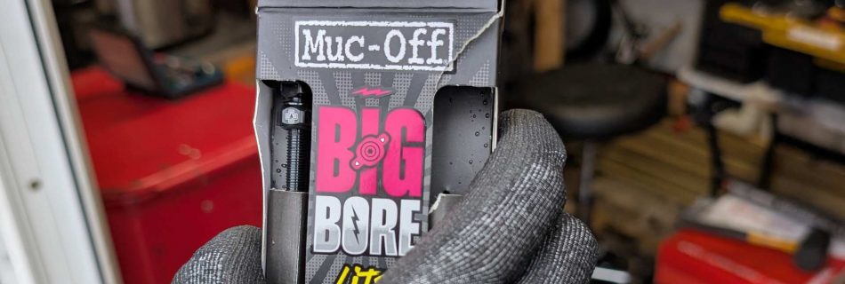 product review - muc off big bore. picture showing a hand holding an opened box of big bore tubeless valves